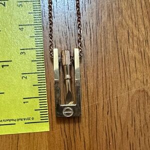 Gold Tone Screw and Screwdriver Pendant Necklace.